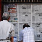 Reading newspapers in Hanoi, Vietnam